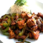 A plate of Black Pepper Chicken Fry served with some steamed rice.