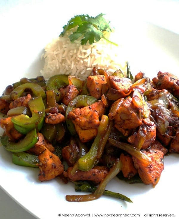 A plate of Black Pepper Chicken Fry served with some steamed rice.