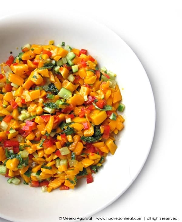 A bowl of Spicy Mango Salsa garnished with fresh cilantro.