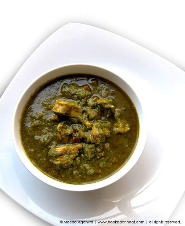 Recipe for Saag Chicken (Chicken cooked in Pureed Spinach) taken from www.hookedonheat.com. Visit site for detailed recipe.