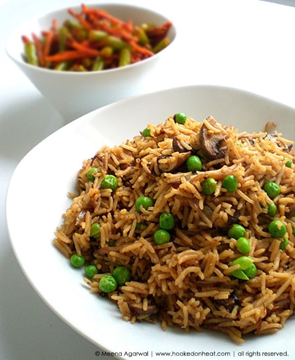 Recipe for Mushroom & Peas Pulao taken from www.hookedonheat.com. Visit site for detailed recipe.