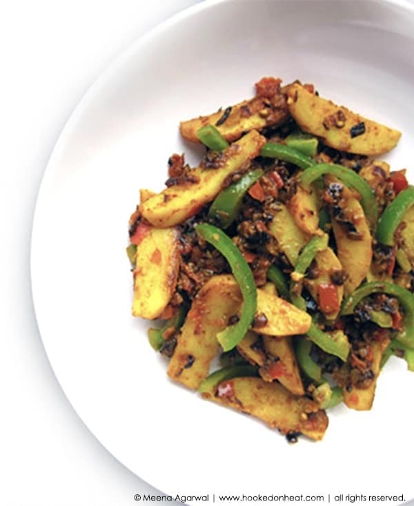 A bowl of Aloo Shimla Mirch (Sauteed Potatoes and Peppers).