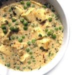 A bowl of Paneer Methi Malai with Peas.