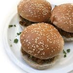 A plate of three Bun Keema sandwiches garnished with fresh cilantro