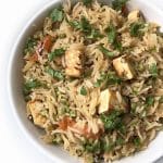 A bowl of Paneer Pulao garnished with fresh cilantro.