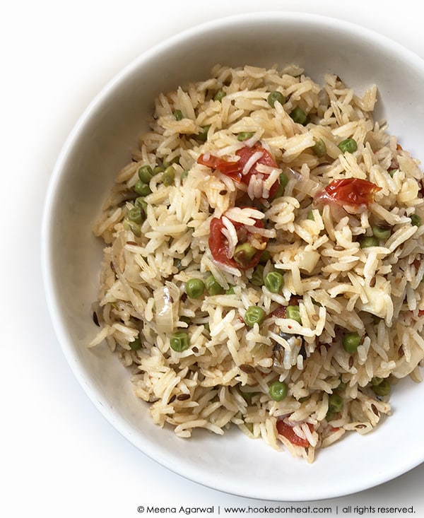 A bowl of Matar Pulao, flavoured rice cooked with Peas, Tomatoes and Spices