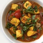 A bowl of Paneer Jalfrazie (Stir-fried Paneer in mild Tomato Sauce) garnished with fresh cilantro.