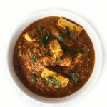 A white bowl of Dahiwali Paneer which is a low-fat version of the classic Paneer Makhani, garnished with finely chopped fresh cilantro.
